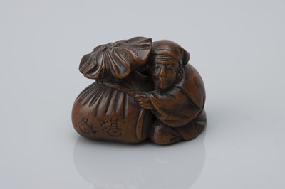 Lot 75 - A Meiji Period Boxwood Netsuke as a Man with Bag of Õni