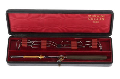 Lot 9 - A Wire Needle Holder and Needle Set