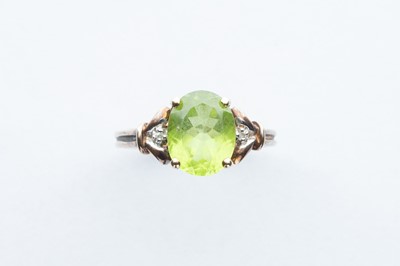Lot 81 - An Oval Peridot &  Chip Diamond Ring